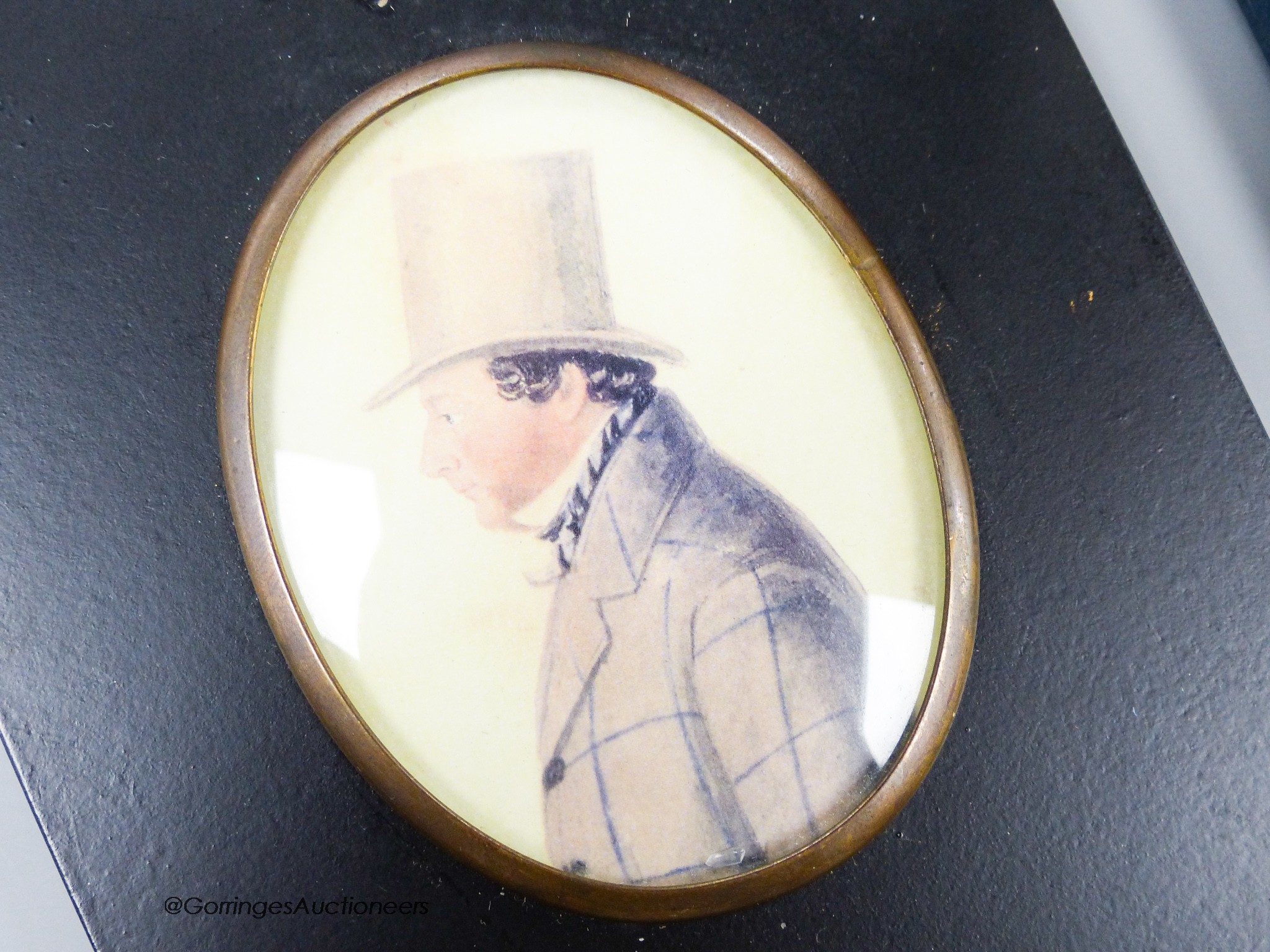 A 19th century watercolour of a gentleman in a top hat and boxed Dunhill lighter